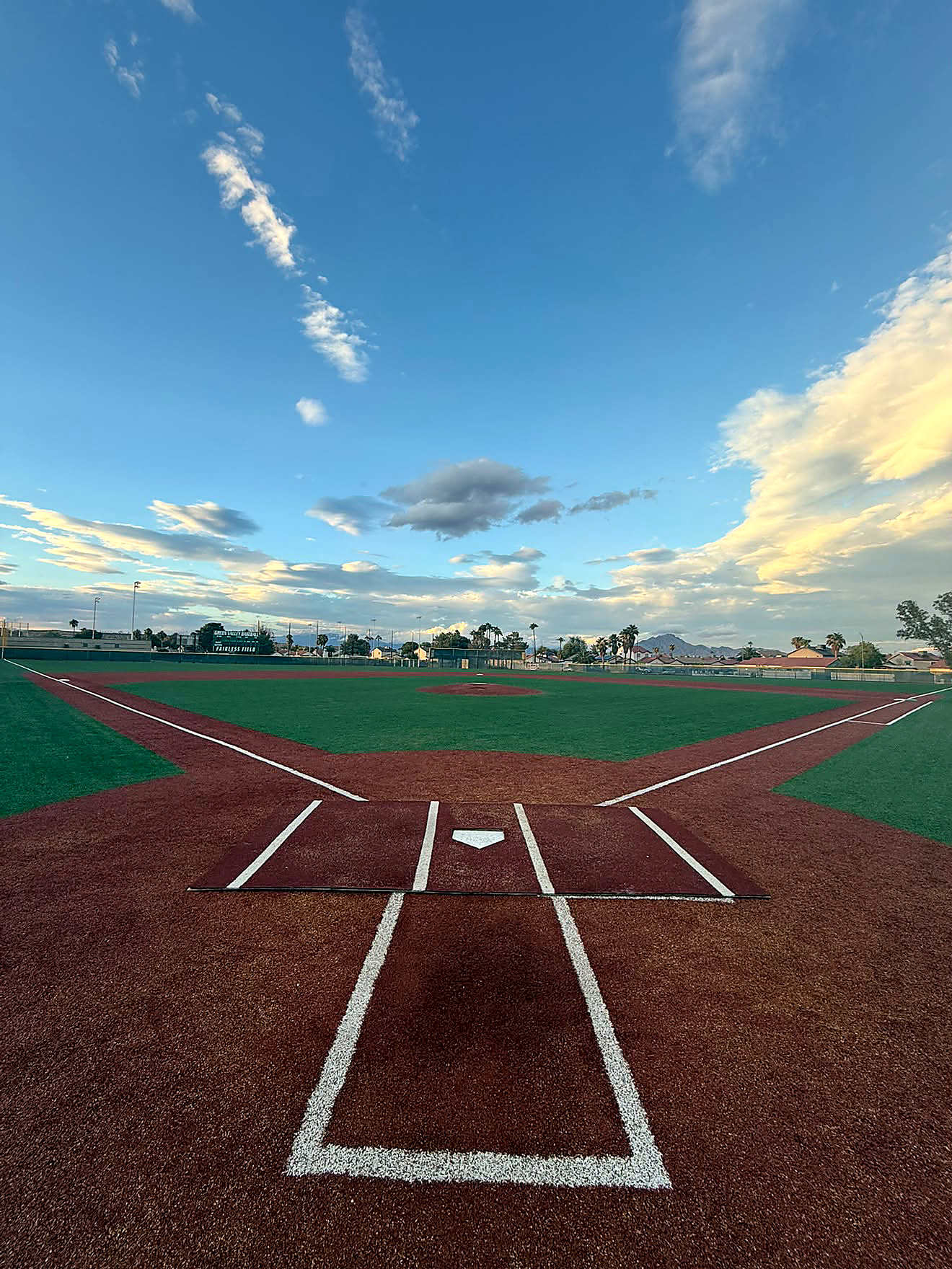 Green Valley High School baseball field at sunset, viewed from behind home plate